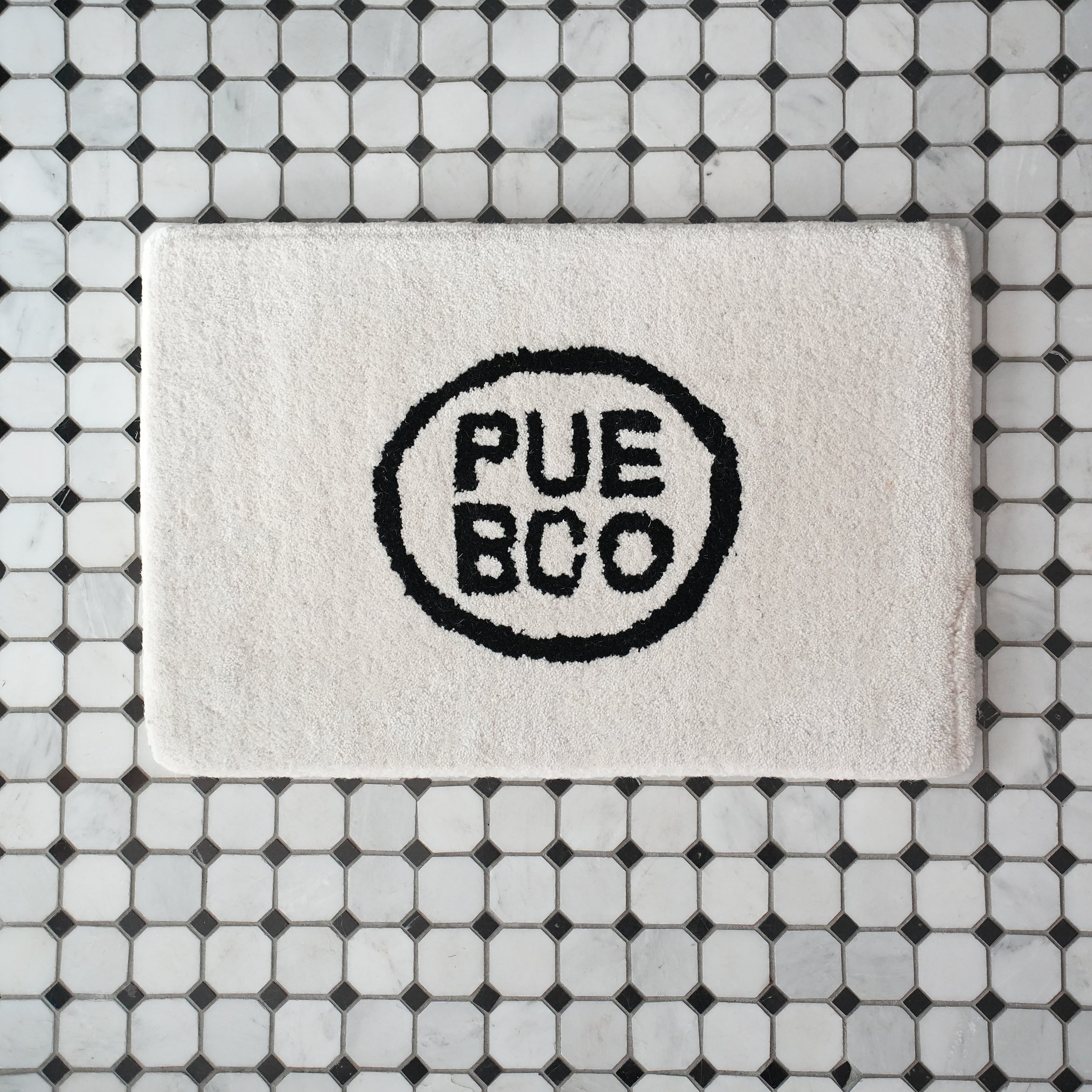 TUFTED MAT / PUEBCO LOGO