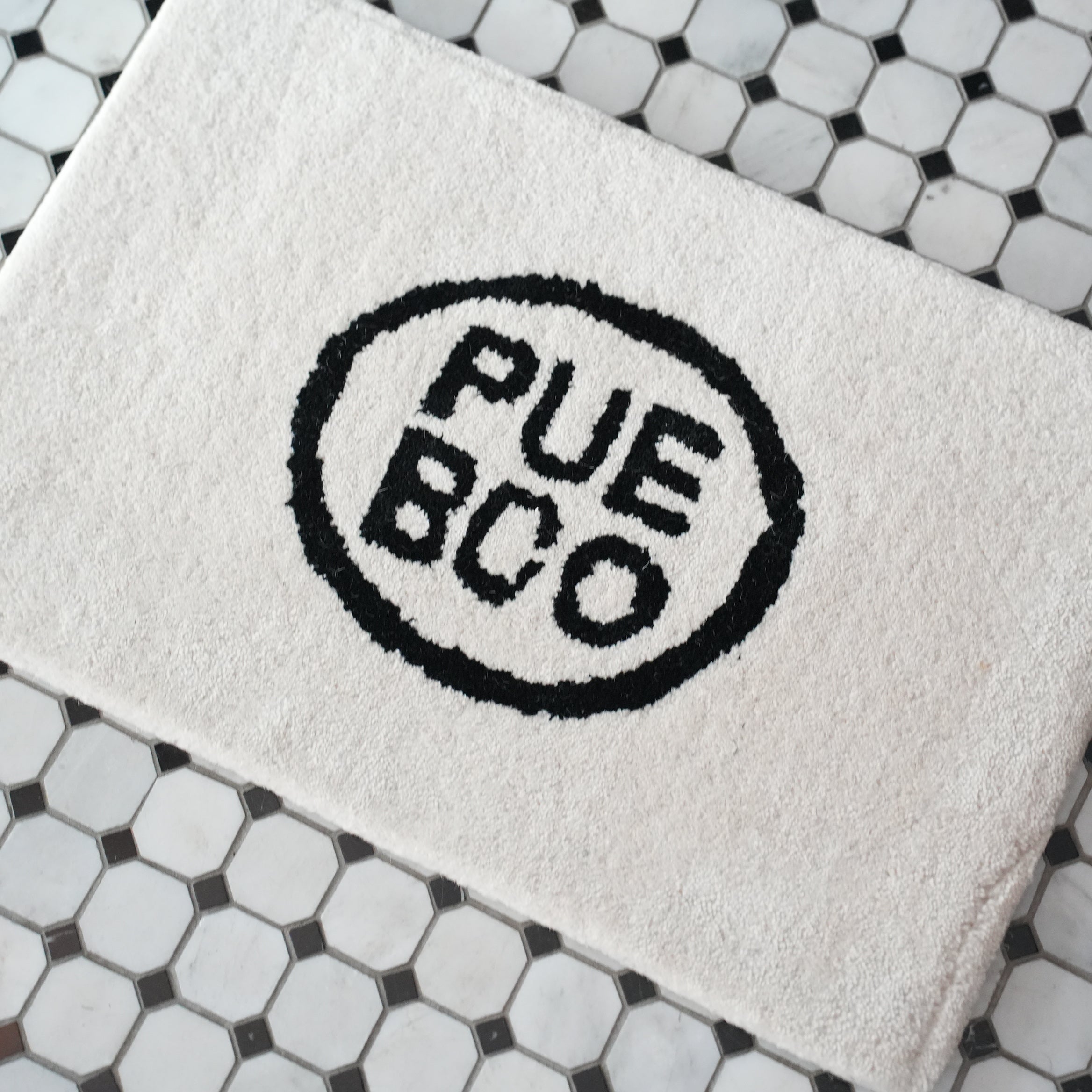 TUFTED MAT / PUEBCO LOGO